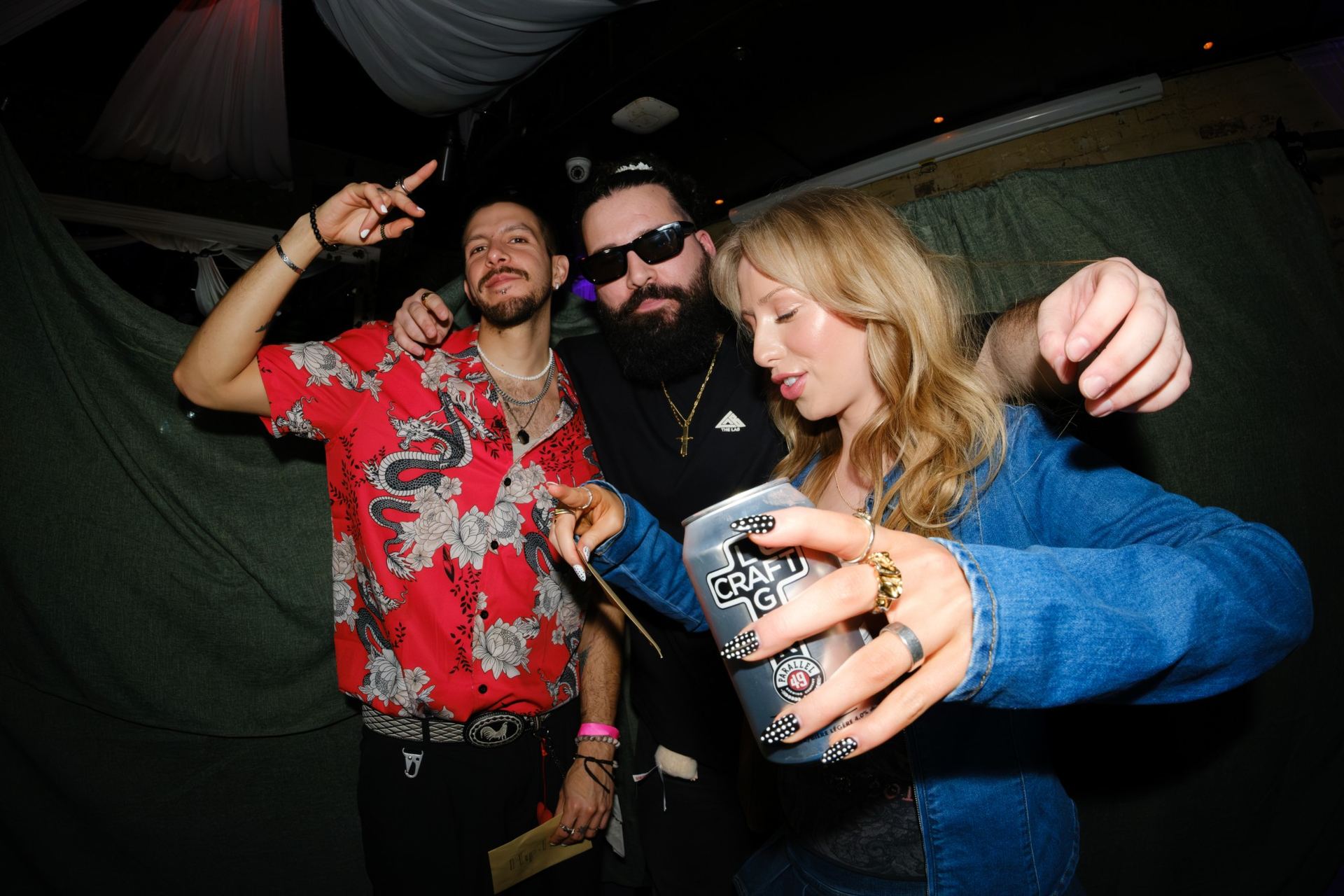 Guests raising a Parallel 49 beer at a partner event
